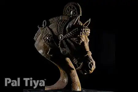 An ornate carved horse head sculpture in a dark metallic finish, shown against a solid black background with a 'Pal Tiya' brand logo in the bottom-left corner.